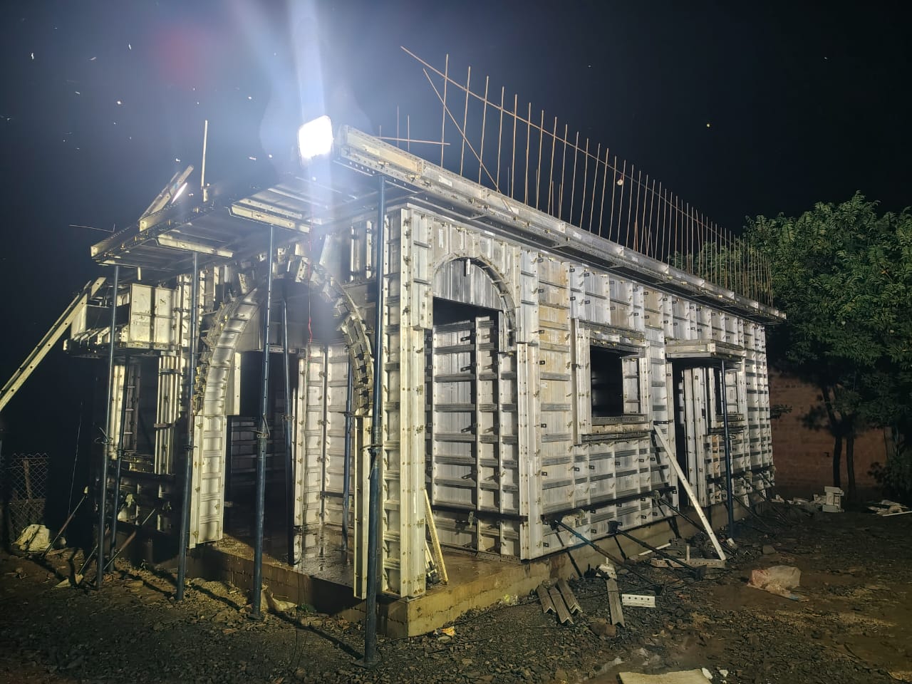 Aluminium formwork panel installation at night